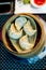 Chinese ravioli on a wooden cylinder plate