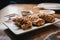 Chinese roast pork puffs on a white plate on a table