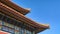 Chinese roofs with figurines on the blue sky background. The Imperial Palace in Beijing