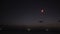 Chinese sky lantern flying away at night.