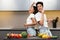 Chinese Spouses Dancing In Kitchen Having Fun Cooking Together