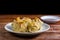 Chinese Steamed Dumpling, Shumai on white dish served with soy sauce on wooden table. Delicious Dimsum pork