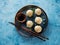 Chinese steamed dumplings in a plate with soy sauce and chopsticks