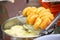 Chinese style deep fried dough buns in hot oil street food