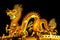 The Chinese style Golden statue of a magnificent golden king dragon with light up illuminated at night