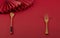 Chinese style red background and red folding fan with wooden fork and wooden spoon