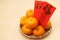 Chinese tangerines in basket with Chinese New Year red packets - Series 2