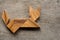 Chinese tangram puzzle in cat sitting shape on wooden background