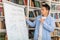 Chinese Teacher Man Teaching Writing On Whiteboard In Modern Classroom