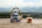 Chinese teapot and cup with green tea on a wooden table on a background of scenic mountains landscape.