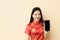 Chinese teen girl showing smart phone blank screen dressing Qipao traditional cloth