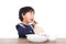 Chinese three-year-old girl eating on white
