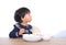 Chinese three-year-old girl eating on white