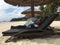 Chinese tourist cover up on a beachchair on the beach