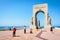 A chinese tourist family taking photos of each other in front of the memorial to the Eastern Army in Marseille, France