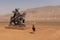 Chinese tourists taking pictures in front of a statue near the Flaming Mountains, Xinjiang