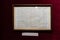 Chinese traditional empty paper with black line grid table for writing letters in picture frame on red cloth wall