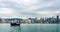 Chinese traditional junk boat in front of Hong Kong skyline