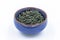 Chinese Wild Green tea. Ye Sheng Lu Cha in a blue ceramic bowl