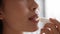 Chinese Woman Applying Lip Balm Moisturizing Lips In Bathroom, Cropped