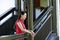 Chinese woman in cheongsam stand in wooden stairs in Mudu ancient town