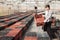 Chinese woman gardener lays empty boxes in a greenhouse