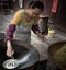 A Chinese Woman Making Traditional Vermicelli