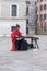 Chinese woman is playing a traditional instrument in a square,the emotion from her music is sadness