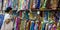 Chinese woman shops for fabric rolls at market stall