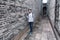 A chinese woman standing in narrow alley