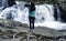 Chinese woman taking pictures of waterfall