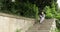 Chinese woman talking on a cell and very angry outdoors on a stone stairways