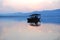 Chinese wooden boat drifting on a lake in sunset