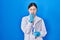 Chinese young woman working at scientist laboratory looking stressed and nervous with hands on mouth biting nails