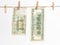 Chinese yuan and American dollars hang on a rope on a white background