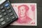 Chinese yuan banknote macro and calculator. Black background. Financial concept.