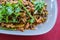 Chinese Yunnan fired mixed mushroom on white plate on red table