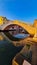 Chioggia - First rays of sunrise illuminate steps of bridge Ponte di Vigo in Italy