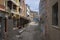 Chioggia, ITALY - June 5, 2022: Pictoresque narrow streets of old town Sottomarina, group of houses in sunlight, blue sky