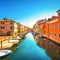 Chioggia town in venetian lagoon, water canal and church. Veneto, Italy