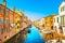 Chioggia town in venetian lagoon, water canal and church. Veneto, Italy