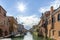 Chioggia town in venetian lagoon, water canal and sun. Veneto, Italy, Europe. Historic center of Chioggia. Sunny day in Chioggioa.