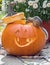 chipmunk peers inside a smiling jack o lantern