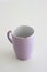 Chipped coffee mug on white background, shallow depth of field