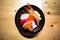 Chirashi sushi, Japanese food rice bowl with raw salmon sashimi, mixed seafood, top view, darken edge, center aligned with copy sp