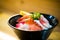 Chirashi sushi, Japanese food, rice bowl with raw salmon sashimi, scallop, shrimp, surf clam, salmon eggs, octopus, tuna, and