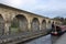 Chirk aqueduct and viaduct on the Llangollen canal, on the border of England and Wales. With a barge crossing