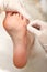 Chiropodist removes skin on a wart