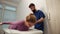 Chiropractic adjustment. Woman suffering from neck pain. Professional massage