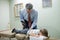 Chiropractor Adjusting Child in Office